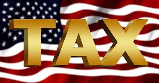 Gold Letters Saying Tax on US Flag