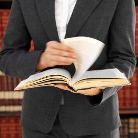 Lawyer attorney reading law book