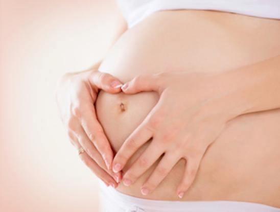 Pregnant Woman holding Stomach
