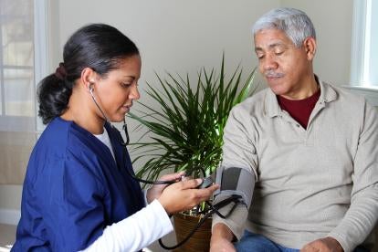 healthcare worker and elderly man in nursing home