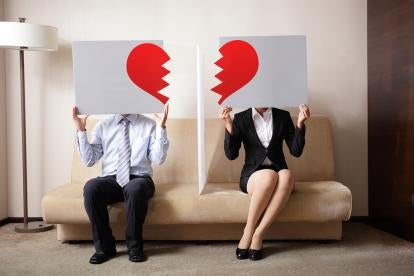a divorcing couple holding broken heart graphics