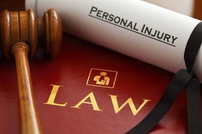 law book with gavel and personal injury scroll 