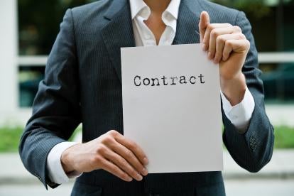 suited employee holding a contract, government contracting guidelines