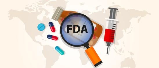 FDA with drugs and magnifying glass 