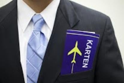 businessman with airplane ticket, H-1B visa, New York