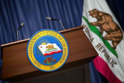 Gavin Newsom's podium with the California flag overlooking all new legislation