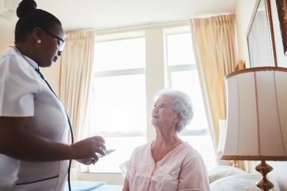 Home Hospice trends a happy senior woman visited by her visiting nurse