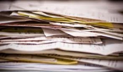 stack of tax forms, phishing scams