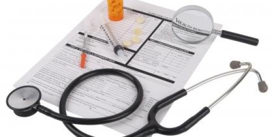 health insurance forms with pills and syringes 