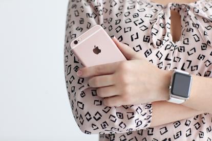 Holding iPhone and wearing Apple Watch, Apple v. Samsung