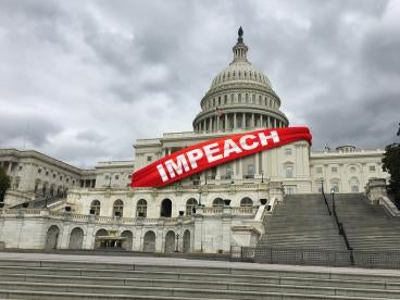 Impeach Banner draped across capitol