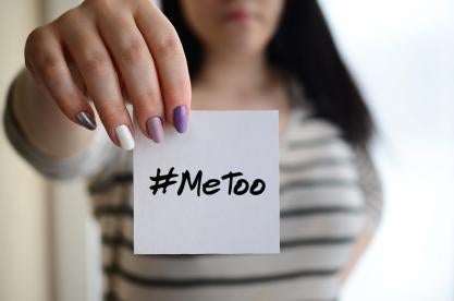 woman holding postit with #MeToo 