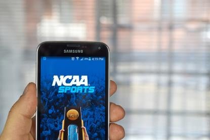 viewer watching NCAA Championship game on his phone