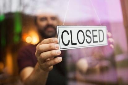 Closed sign in business window