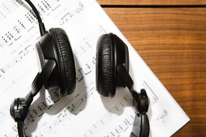 musician's headphones and sheet music making a living with blockchain tech