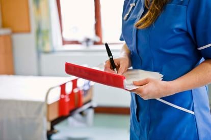 nurse surveying corporate compliance plan documents in nursing home