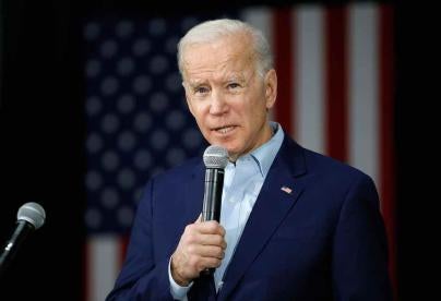 Joe Biden speaking into a Microphone
