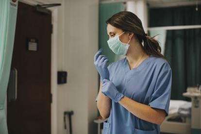 Nurse with gloves considering Changes to Health Care and AKS statutes