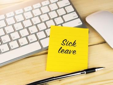 Sick Leave on a yellow Post-It Note