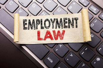 a scroll stating Employment Law unfurled on a keyboard