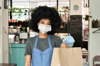 Restaurant Worker Takeout with COVID precautions like mask and gloves