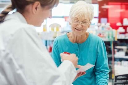 senior citizen receiving her prescription