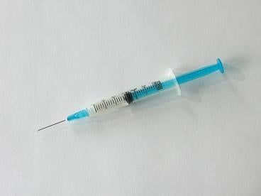 Opioid Class Action Litigation Update: Syringe on white background