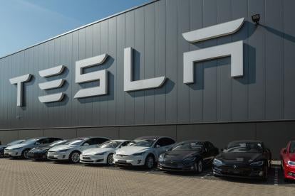 electric cars parked in front of TESLA company