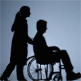 Woman Pushing Man in Wheelchair