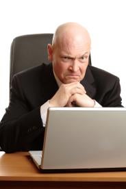Businessman looking at computer - not happy