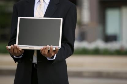 business person holding a computer, hiring IT person