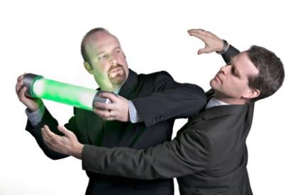 two professionals fighting over an abstract substance green matter in a tube  in a intellectual property battle 