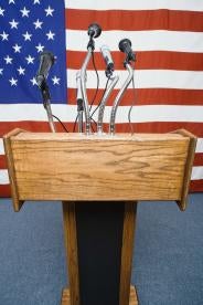 US Flag behind podium in international speech