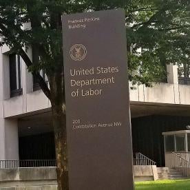 Department of Labor DOL building sign, where FLSA guidance is issued