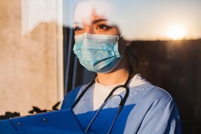 Healthcare worker in mask OSHA Protecting Workers: Guidance on Mitigating and Preventing the Spread of COVID-19 in the Workplace