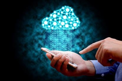 a cloud depicting cybersecurity hovering over a stream of data of 1s 0s from a businessman's smartphone