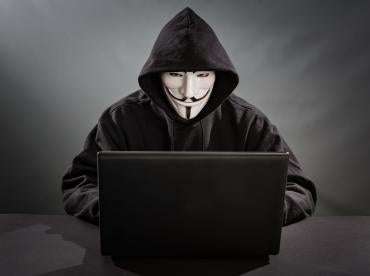 Anonymous global hacker engaging in identity theft 