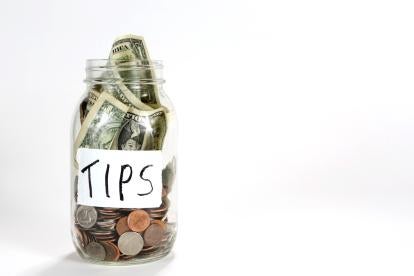 a tip jar filled with coins and bills