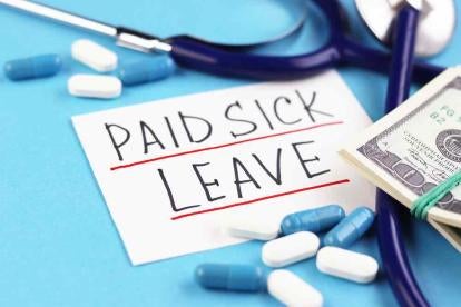 Paid Sick Leave on a Post it Note with Health Care Supplies