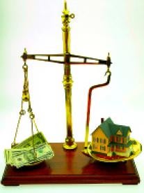 Scales of justice with house and money