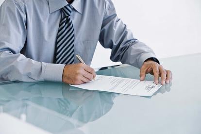 Man Signing Document