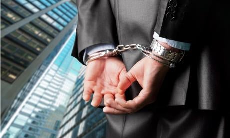 banking fraud, corporate man in handcuffs