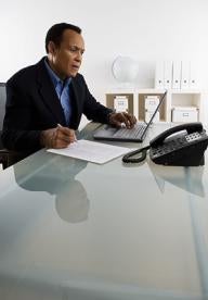 man working at the computer, managing a law firm