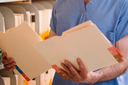 doctor comparing records for medicare
