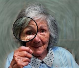 elderly woman with magnifying glass 