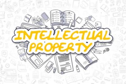 intellectual property in yellow on illustration of notebooks and documents