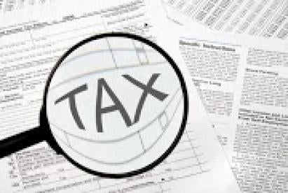 Tax Forms with Magnifying Glass