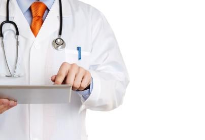 Doctor with tablet, clinical reports in EMA, commercially confidential information