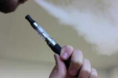 person vaping an e-cigarette that possibly causes vape lung disease